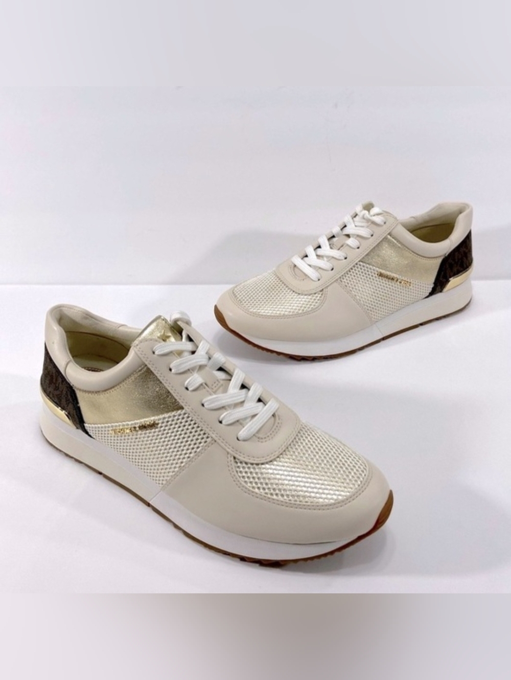 Michael Kors Allie Trainers in a white and gold colorway. Size 6.5